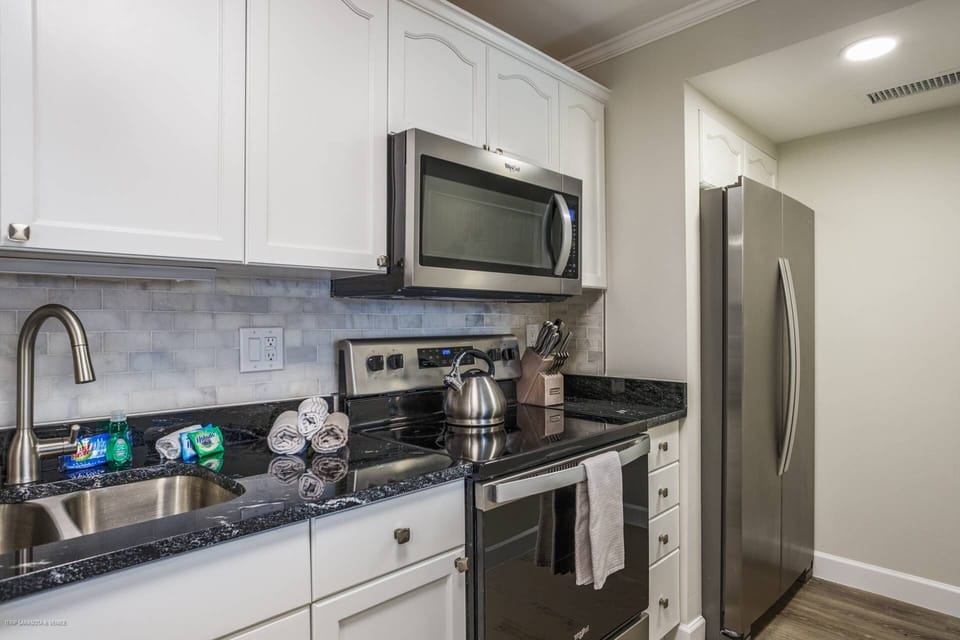 Modern updated kitchen stocked with basic appliances such as coffeemaker and blender, etc.