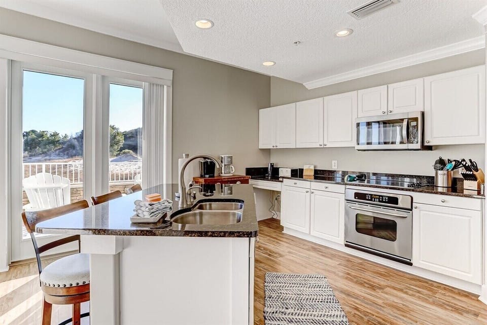 Bright and Open Kitchen with Plenty of Counterspace.  Partial view of ocean from kitchen