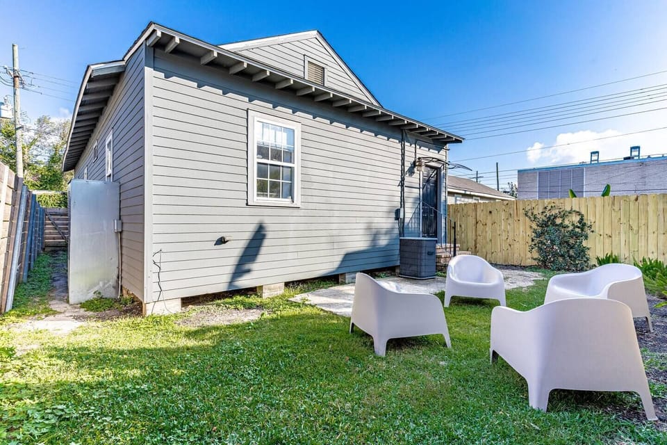 Lush backyard w/ lounge chairs — a peaceful outdoor retreat to relax & unwind.
