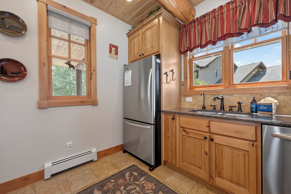 Warm wood accents and natural light create a welcoming feel in your fully equipped kitchen, ready for preparing meals during your stay.