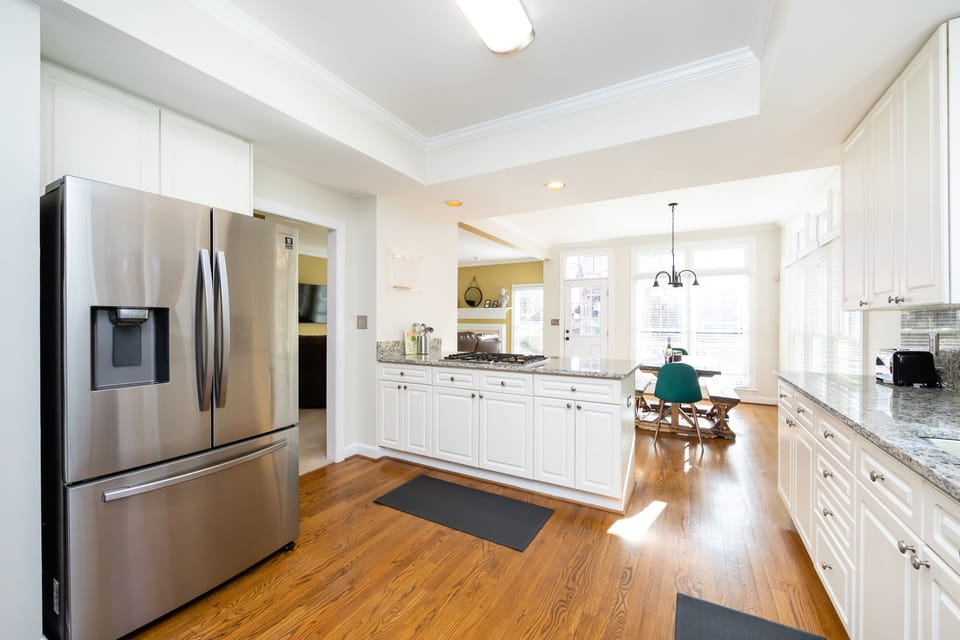 All white Lux kitchen with marble counter tops and new appliances