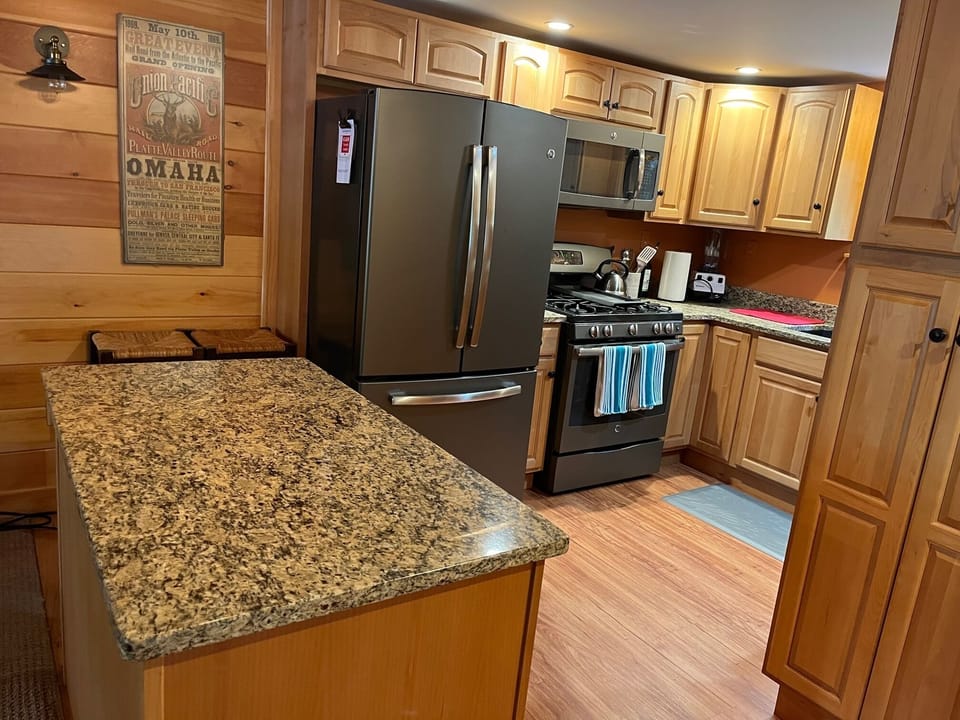 Kitchen with granite counter tops, gas stove, dishwasher, microwave