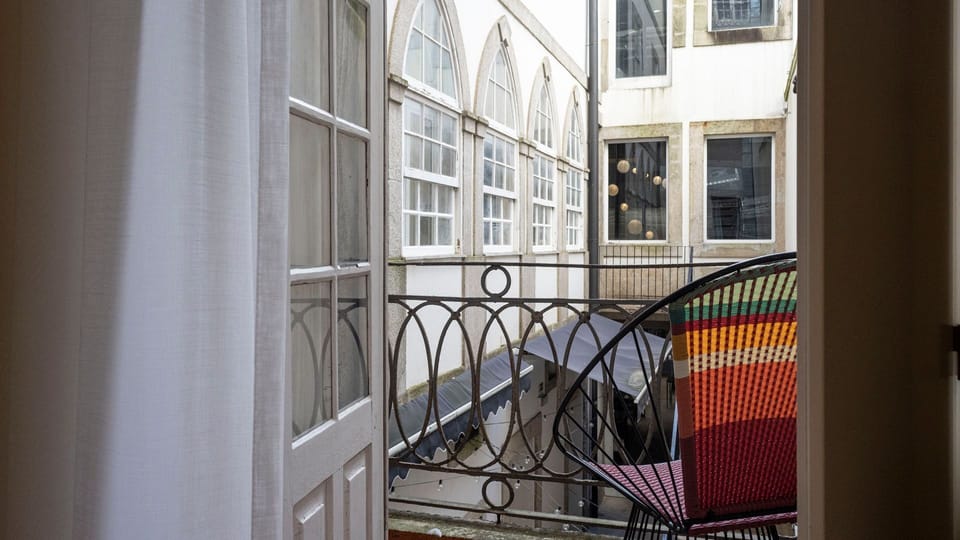 Step out onto your private balcony and soak in the vibrant city atmosphere, a perfect spot to enjoy your morning coffee or an evening drink while watching the world go by. The intricate ironwork railing adds a touch of classic elegance to your outdoor esc
