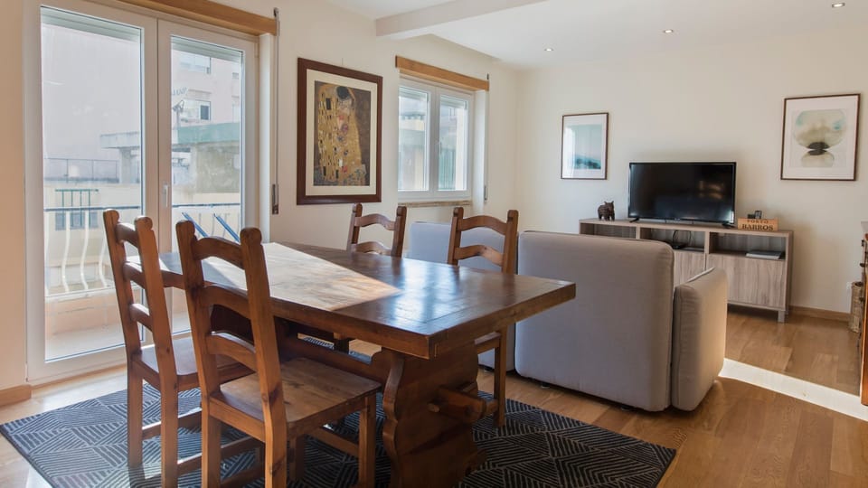 A lovely living space and dining area with access to the balcony