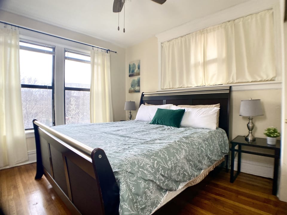 King bedroom with bright windows