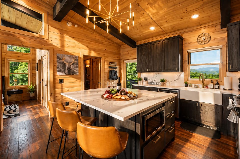 The combination of black cabinetry and white countertops adds elegance to this fully equipped kitchen, designed for both style and function.