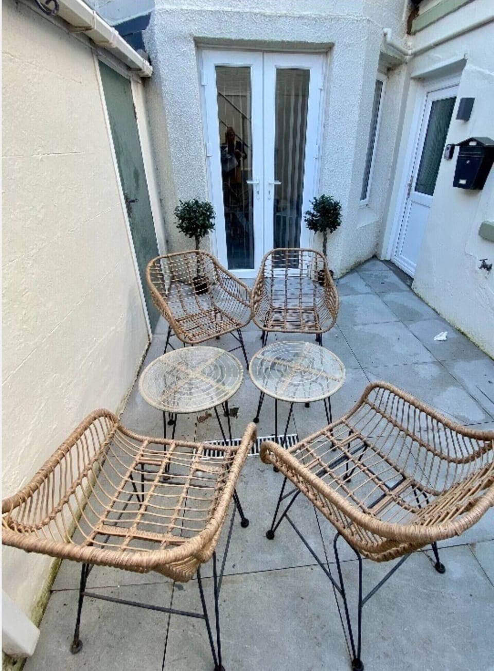 Courtyard enclosed with a gate and seating.