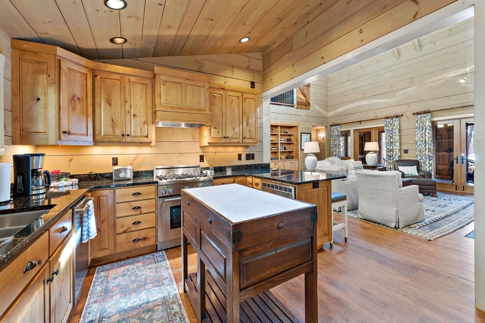 Kitchen with wine cooler, gas range, dishwasher, and drip-style coffeemaker.