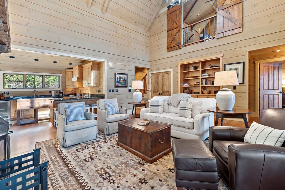 Spacious main-level living room with wood-burning fireplace and TV.