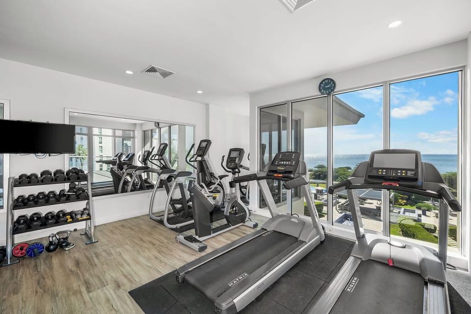 Bright, fully-equipped fitness center with modern cardio machines, free weights, and stunning water views. Capture ocean glimpses while maintaining your workout routine.