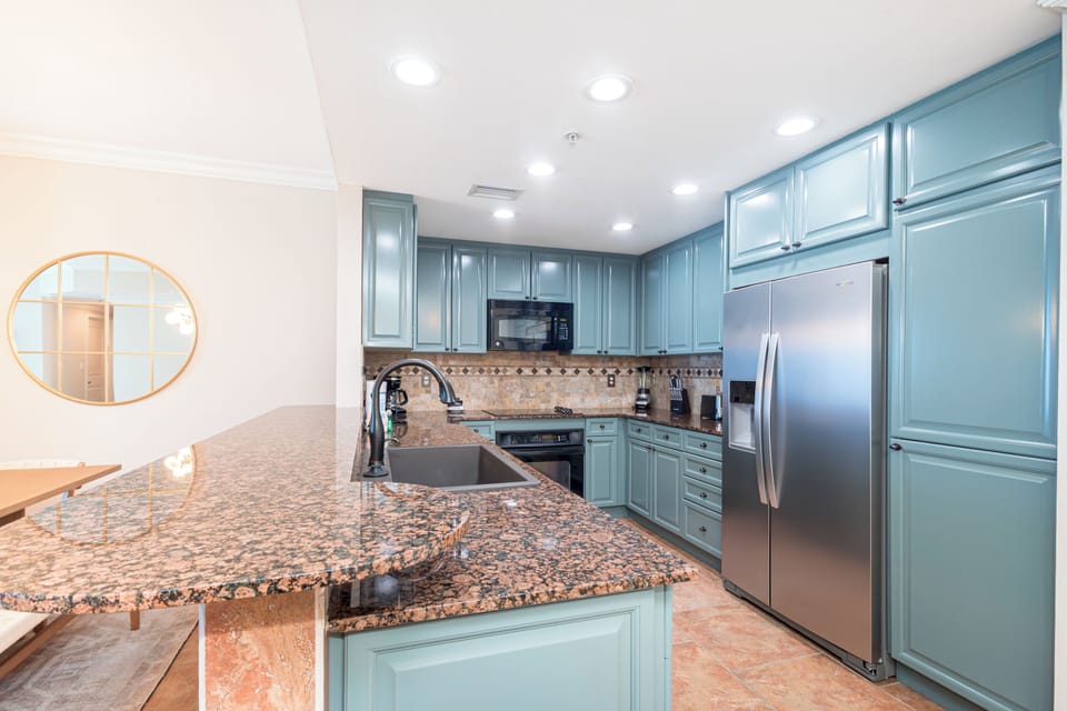 This fully equipped kitchen with granite counters, stainless appliances, and stylish cabinetry gives you all the comforts of home for preparing meals during your stay.
