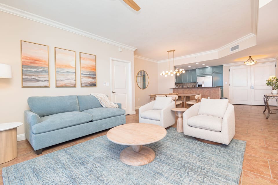 Unwind in your airy open-concept living area, where coastal-inspired decor meets thoughtful design. Relax on plush seating as warm lighting sets the mood for memorable evenings together.