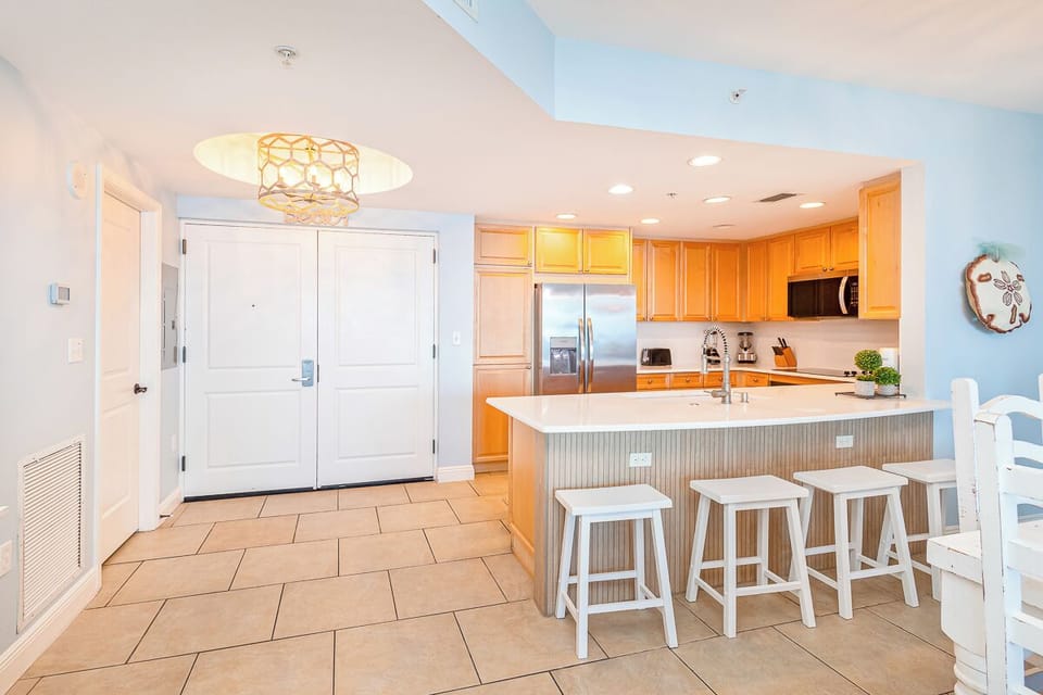 Your bright, open kitchen welcomes you with warm wood cabinets, gleaming countertops, and modern stainless appliances—perfect for morning coffee or evening meals.