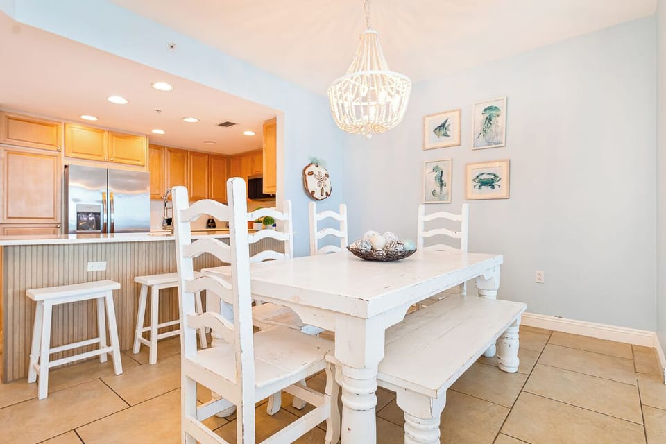 Gather around your charming white dining table while coastal light filters through, creating perfect moments for family meals and morning coffee.