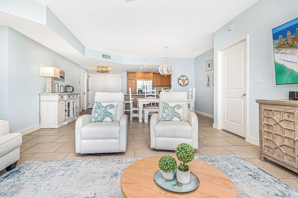 Your elegant open-plan retreat features a spacious living room flowing into a modern kitchen, perfect for relaxing evenings.