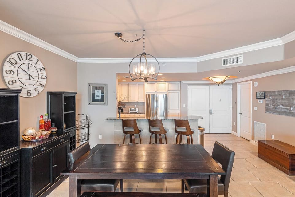 Step into your inviting open-concept space where dining flows seamlessly into the kitchen. Warm wood tones and thoughtful lighting create the perfect atmosphere for gathering with loved ones over meals and conversation.