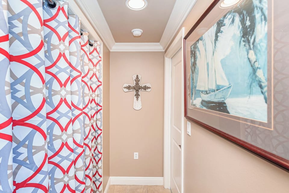 A welcoming hallway features elegant crown molding and soft lighting overhead, setting a warm, peaceful tone as you arrive.