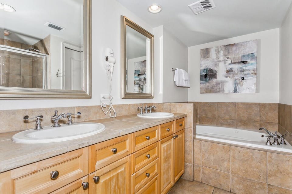 Unwind in your spacious bathroom with dual sinks, a soaking tub, and elegant finishes that invite relaxation after your day.