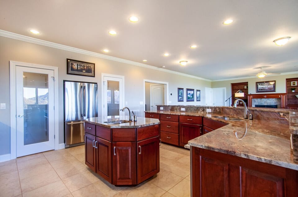 Rich wood cabinetry and stylish granite countertops blend perfectly in this sophisticated kitchen.