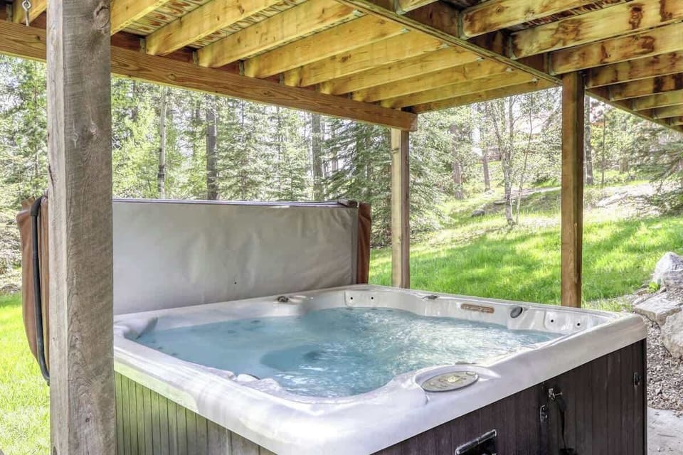 Square hot tub on the on the patio on the lower level- the perfect place to relax after a long day of skiing or hiking!