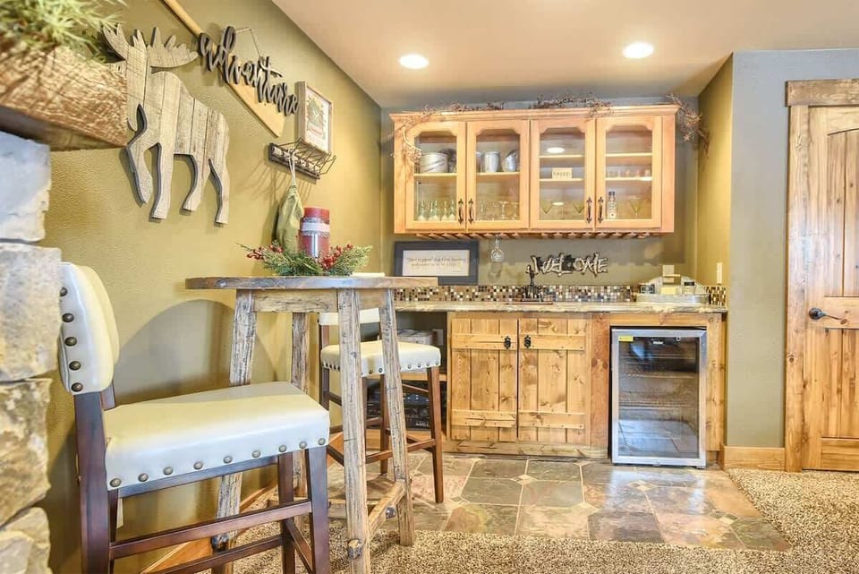 Lower level table with 2 chairs, and wet bar