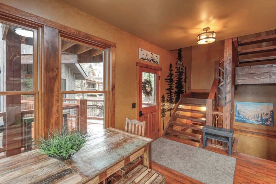 Dining table, front entrance, and the staircase to the upper level