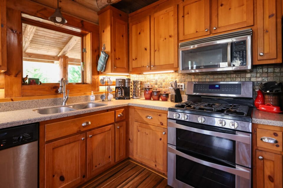 Cook up a feast in the open kitchen with a bar island, seating, and modern appliances.