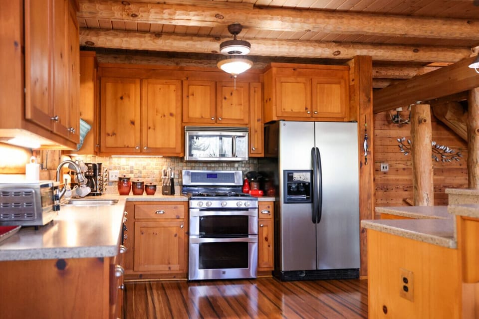Cook up a feast in the open kitchen with a bar island, seating, and modern appliances.