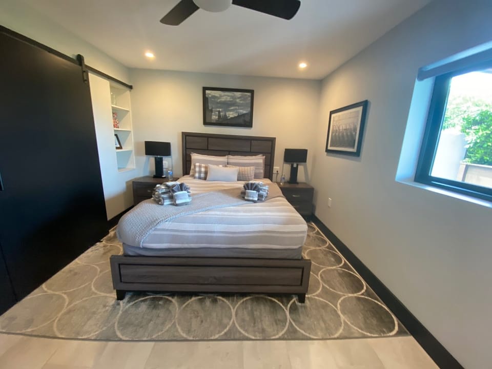 Queen bed with large closet & light filled room.