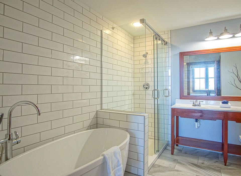 The master bathroom has a beautiful soaker tub and floor-to-ceiling tile walk-in shower!