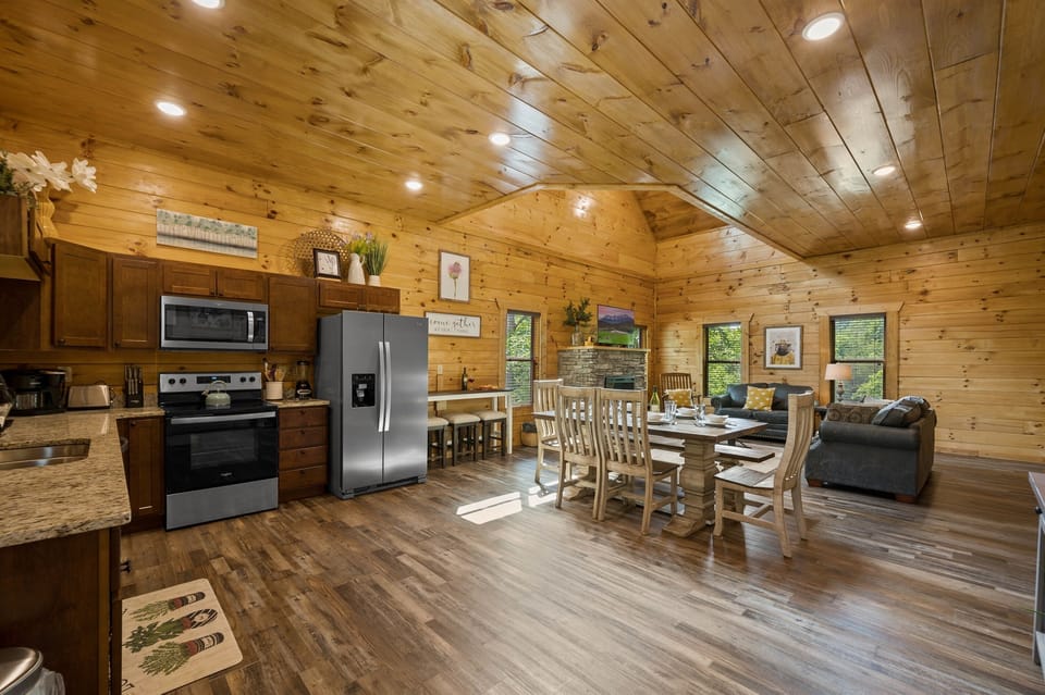 Get ready to fall in love with our open concept living, dining, and kitchen area, the heart of our cabin and the perfect destination for your Smoky Mountains adventure.