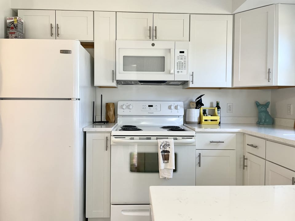 Kitchen is fully equipped with cups, mugs, plates, bowls, cooking pots, ect