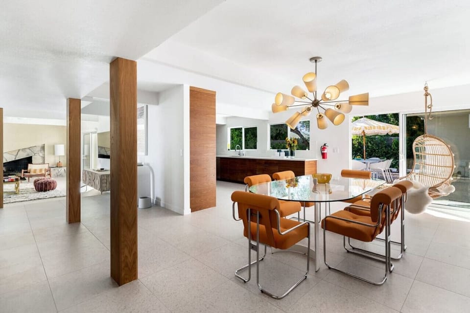 Mid-century magic – where sleek glass, warm wood, and vibrant accents create a timeless look.