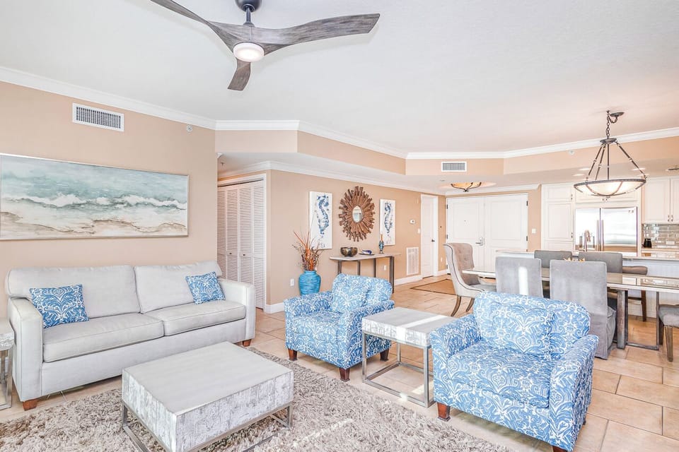 Relax in your coastal-inspired living space with ocean artwork, plush blue seating, and modern amenities that make you feel right at home.
