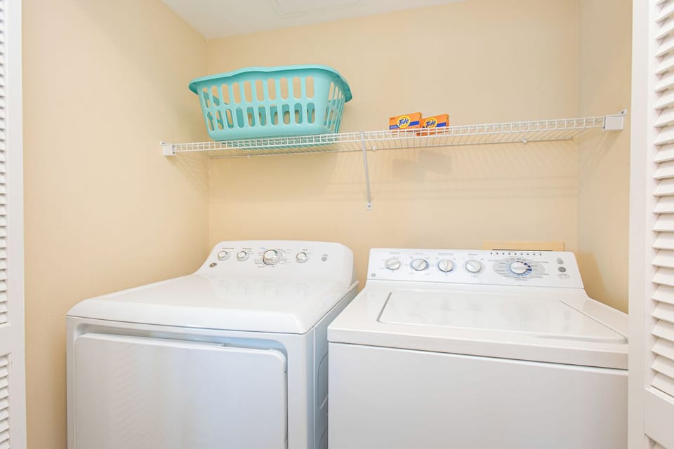 Freshen up effortlessly with your own dedicated laundry space, featuring a full-size washer and dryer with convenient overhead storage for all your vacation essentials.