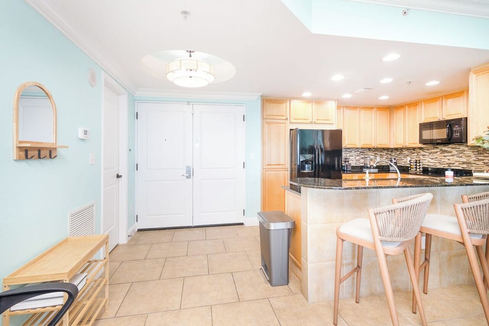 Your sleek kitchen features granite counters, modern appliances, and a cozy breakfast bar where you can enjoy morning coffee.