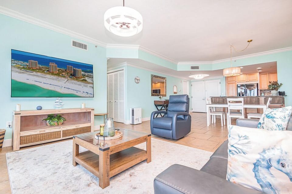Relax in the inviting living area featuring coastal décor and ample seating.