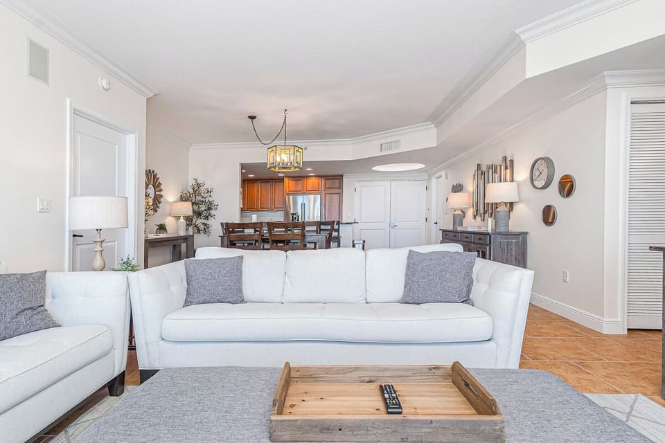 Sink into plush seating in your sunlit living space, where elegant coastal touches and an open layout invite you to unwind. The adjoining kitchen and dining area make it easy to gather, cook, and savor moments together.