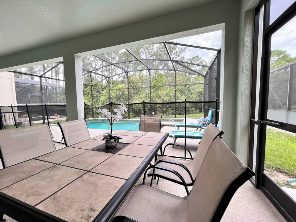 Seating area in private screened in pool patio