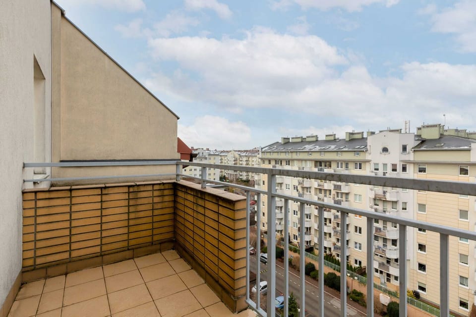 A balcony with outdoor furniture and a city view.