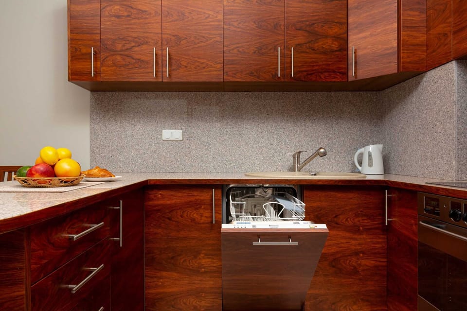 A compact, modern kitchen equipped with all necessary appliances and utensils.