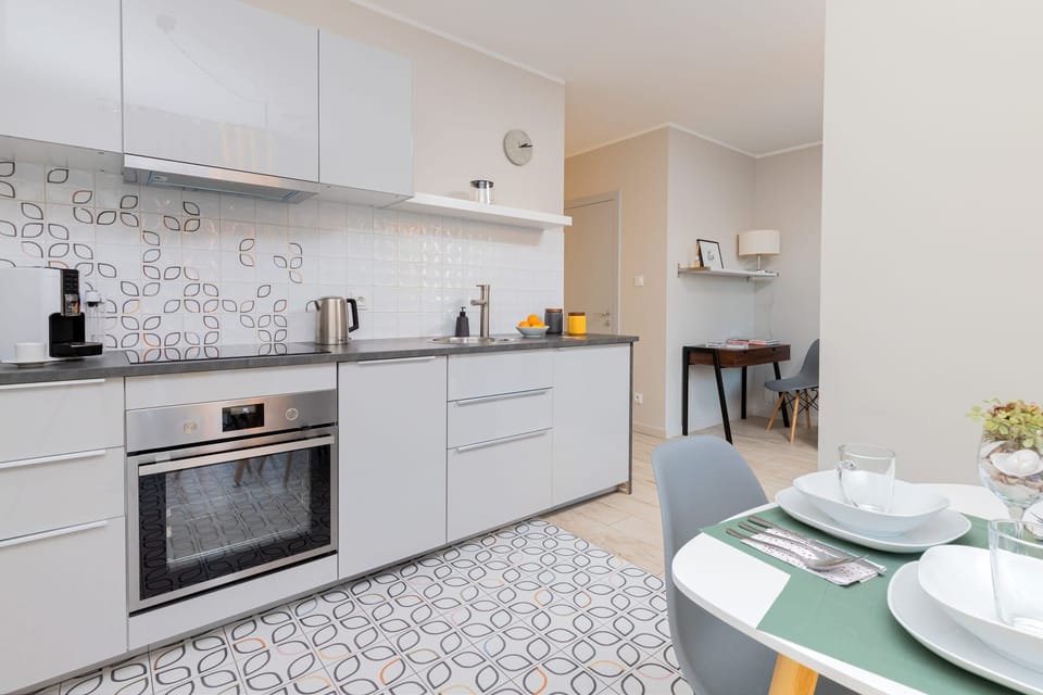 A modern kitchen with high-quality finishes, ample storage, and an adjacent dining area. Perfect for cooking and entertaining.