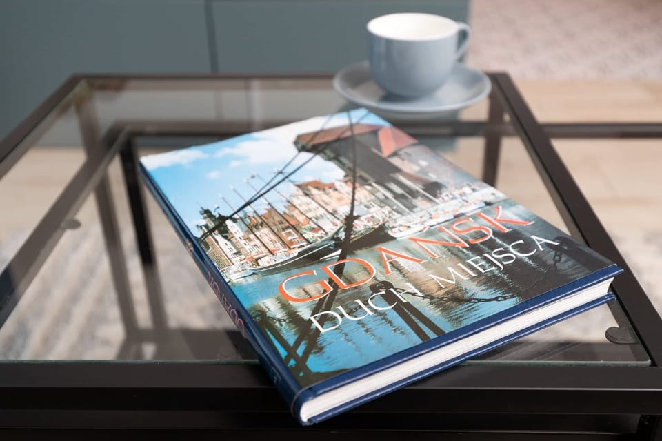 Close-up of a coffee table with a guidebook about Gdansk.
