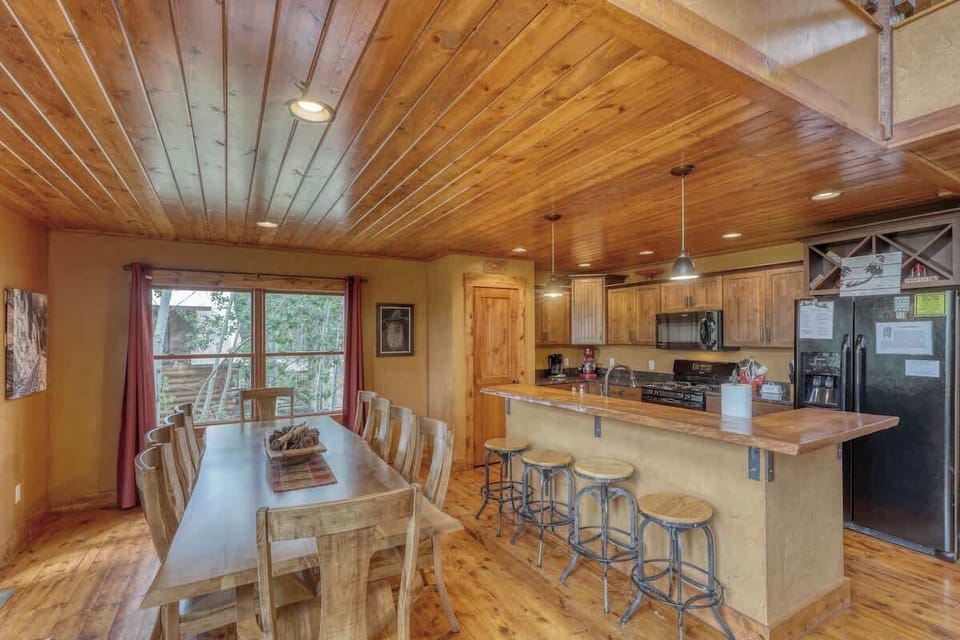 Wood ceilings adding unqiuness to this open concept kitchen and dining room 