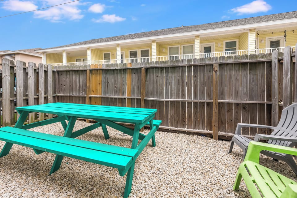 Your private outdoor space features colorful seating where you can enjoy morning coffee or evening meals in the fresh air.