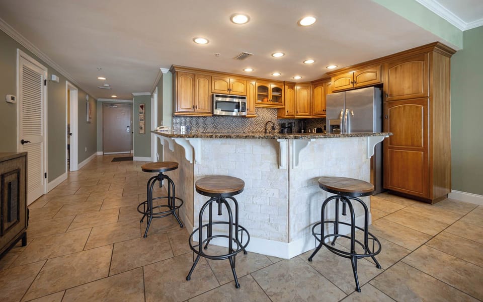 Gather around the stylish bar stools at the kitchen counter, perfect for casual meals and conversation