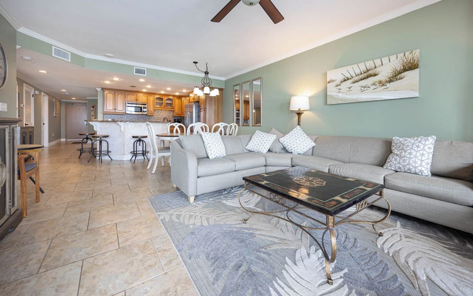Relax in the spacious living area with comfortable seating and a view of the kitchen and dining space nearby