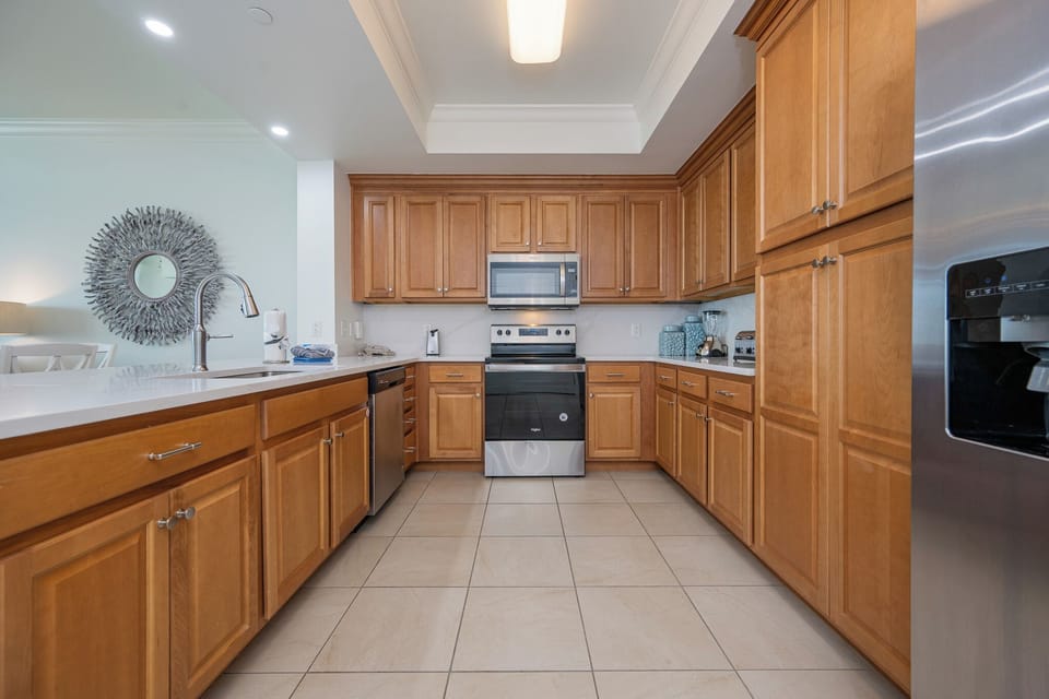 Smooth countertops and gleaming appliances surround you as you prepare family meals in the kitchen