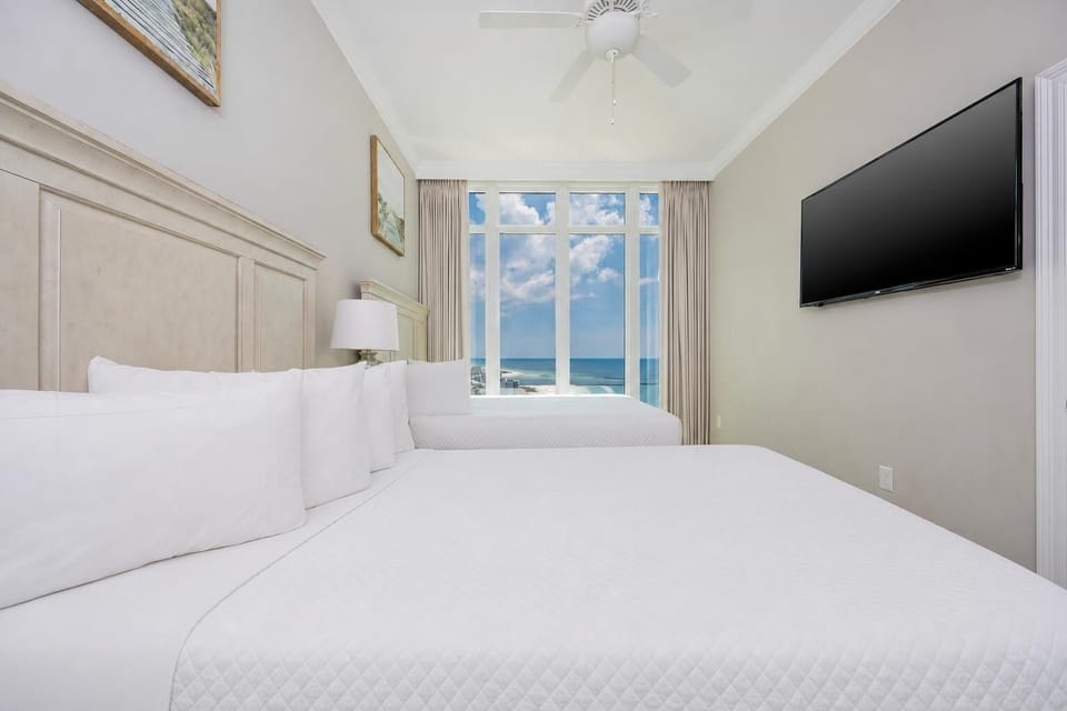 Awake to tranquil mornings in soft queen bedding in this guest room while enjoying stunning beach views
