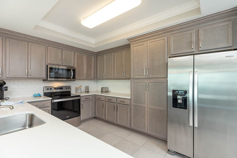 Prepare meals in this kitchen with elegant cabinetry, stainless appliances, and spacious countertops